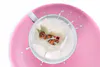 A staged photographic print of a LEGO gingerbread man dipping in milk by New Zealand artist Adam Popovic, available at The Little Gallery Whangamata